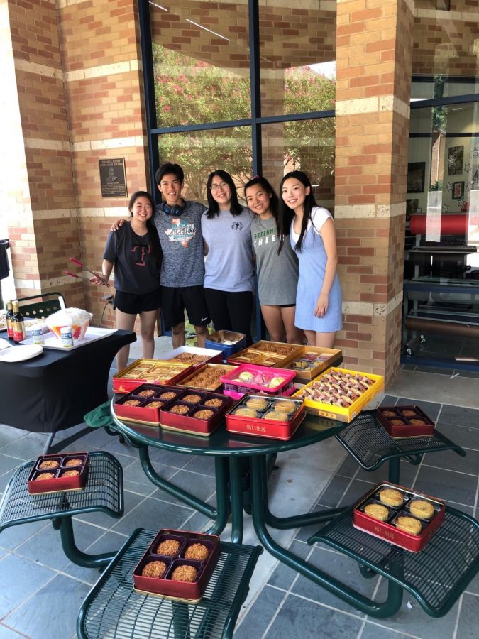 Leaders of the East Asian Affinity Group, shown here  handing out mooncakes during the Upper School’s Mid-Autumn Festival, have criticized acts of discrimination and xenophobia directed at Asian Americans during the Covid-19 pandemic. Sophomore Ashley Shan, far right,  has questioned whether Greenhill School has done enough to support East Asian students. 