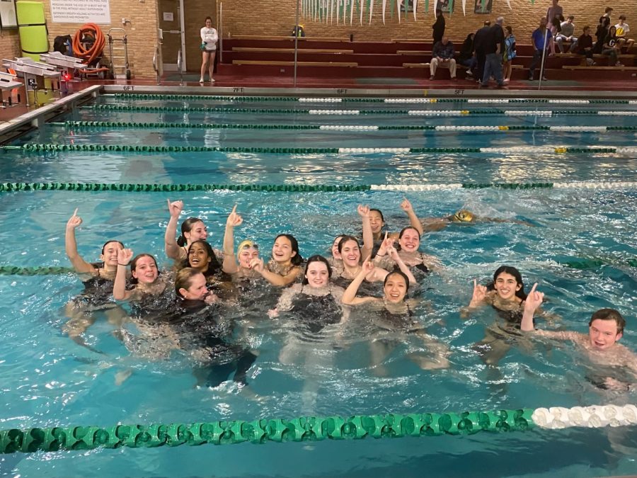 The+Girls+Swim+Team+celebrates+their+win+in+the+pool.+
