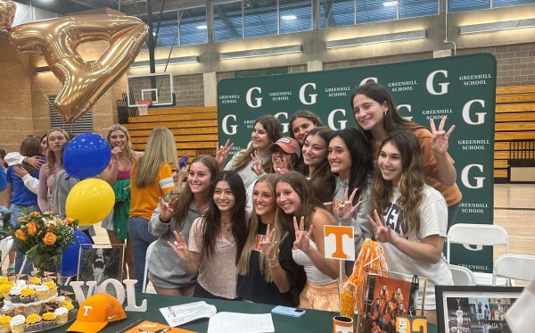 Friends crowd around senior Devin Davis after she signs her National Letter of Intent to the University of Tennessee.